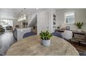 Charming dining area featuring a modern table, stylish chairs, and a view of the adjacent living spaces at 10346 Uvalda Ave, Commerce City, CO 80022