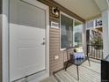 Inviting front porch with a bench and stylish exterior details at 10346 Uvalda Ave, Commerce City, CO 80022