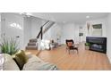 Light and airy living room with fireplace and hardwood floors at 10537 W Maplewood # B, Littleton, CO 80127