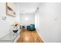 Inviting entryway with light hardwood floors, white walls, and tasteful decor for a modern touch at 4030 W 49Th Ave, Denver, CO 80212