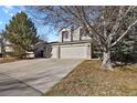 Inviting two-story home features a three car garage and a long driveway at 5521 S Yakima St, Aurora, CO 80015
