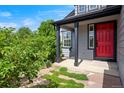 Charming front porch with a striking red door and meticulously maintained landscaping at 8791 Starwood Ln, Parker, CO 80134