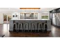 Stylish kitchen island with barstool seating, wine storage, and modern light fixtures overlooking the backyard at 3850 Hopi Dr, Sedalia, CO 80135