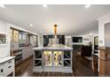 Well-appointed kitchen with stainless steel appliances, an island, wine storage, and ample counter space for entertaining at 3850 Hopi Dr, Sedalia, CO 80135