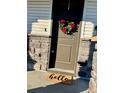 Inviting front entrance features a festive wreath and a welcoming 'hello' doormat at 16357 E 111Th Pl, Commerce City, CO 80022