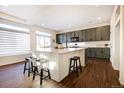 Spacious kitchen featuring a large island with barstool seating and modern appliances at 16357 E 111Th Pl, Commerce City, CO 80022