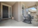 Cozy front porch featuring comfortable seating, perfect for relaxing and enjoying the neighborhood view at 141 Back Nine Dr, Castle Pines, CO 80108