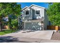 Inviting home exterior featuring a 2-car garage, stone accents, and well-maintained lawn at 11777 Elizabeth Cir, Thornton, CO 80233