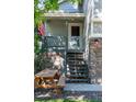 Inviting front porch with stone accents, outdoor lighting, steps to the front door and a picnic table at 11777 Elizabeth Cir, Thornton, CO 80233
