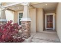 Inviting front porch with stone accents and a charming entryway at 17956 Gypsum Canyon Ct, Monument, CO 80132