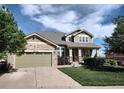 Charming home with a stone facade, a well-kept lawn, and an attached two-car garage at 581 N Flat Rock Cir, Aurora, CO 80018