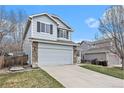 Side view of a two-story home with attached garage, showcasing the well-kept lawn at 23813 Broadmoor Dr, Parker, CO 80138