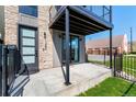 Modern townhome entrance featuring stone accents, black trim, and a private outdoor patio at 1385 N King St, Denver, CO 80204