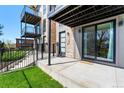 Close-up of modern townhome entrance with stone accents, private patio, and sliding glass doors at 1385 N King St, Denver, CO 80204