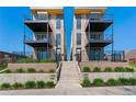 Modern townhomes with stone accents, private balconies, and well-manicured landscaping leading to unit entrances at 1385 N King St, Denver, CO 80204