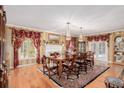 Formal dining room featuring hardwood floors and large windows at 2209 Green Oaks Ln, Greenwood Village, CO 80121