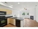 Bright kitchen featuring stainless steel appliances, granite countertops, and an open layout to the living room at 2253 Coronado Pkyn # D, Denver, CO 80229
