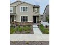 Inviting two-story home with stone accents and a landscaped front yard at 5126 Buckwheat Rd, Brighton, CO 80640