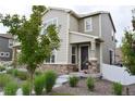 Inviting two-story home with stone accents and a landscaped front yard at 5126 Buckwheat Rd, Brighton, CO 80640