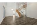 Open entryway with dark wood floors, high ceilings, a staircase, and a chandelier at 134 Laramie Ct, Castle Rock, CO 80104