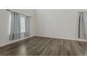 Spacious room featuring dark wood floors, large window, and neutral wall paint at 134 Laramie Ct, Castle Rock, CO 80104