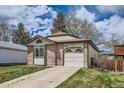 Charming single-Gathering home boasts a manicured lawn, brick accents, and an attached garage at 7661 Gray Way, Arvada, CO 80003