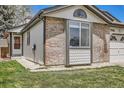 Charming single-Gathering home boasts a manicured lawn, brick accents, and an attached garage at 7661 Gray Way, Arvada, CO 80003