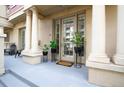 Elegant building entrance featuring stately columns and potted plants adorning the doorway at 1950 N Logan St # 102, Denver, CO 80203