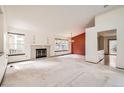 Spacious living room with a fireplace, large windows, and an open layout at 8543 Redstone St, Highlands Ranch, CO 80126