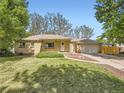 Charming brick ranch home with a well-manicured lawn and two-car garage at 50 Yarrow St, Lakewood, CO 80226