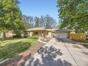 Charming brick home with a well-manicured lawn and an attached garage at 50 Yarrow St, Lakewood, CO 80226