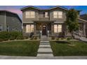 Charming two-story home featuring stone accents, a welcoming front porch, and a well-manicured lawn at 4391 S Nepal St, Centennial, CO 80015