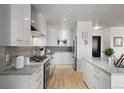Modern kitchen with stainless steel appliances and sleek white cabinetry at 410 Acoma St # 314, Denver, CO 80204