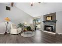 Bright living room featuring wood floors, fireplace and cozy seating, great for relaxation and comfort at 6779 W 79Th Cir, Arvada, CO 80003