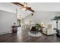 Spacious living room with wood floors, a ceiling fan, and an adjacent dining area, perfect for entertaining at 6779 W 79Th Cir, Arvada, CO 80003