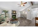 Inviting living room with a striking stone fireplace, wood floors, and abundant natural light at 6779 W 79Th Cir, Arvada, CO 80003