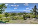 Scenic view of the landscape with a mountain range in the background on a sunny day at 10690 County Road One, Longmont, CO 80504
