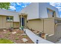 Close up of home showcasing the entrance, brick accents, and tidy landscaping at 3378 Mowry Pl, Westminster, CO 80031