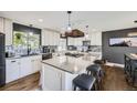Modern kitchen featuring stainless steel appliances, a large island, and a stylish backsplash at 3378 Mowry Pl, Westminster, CO 80031