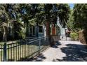 Charming home with a fenced yard, driveway, and beautifully landscaped front yard at 1260 Hudson St, Denver, CO 80220
