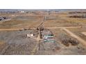 An aerial view displaying the home with outbuildings situated on a vast lot with surrounding countryside at 14624 County Road 12, Fort Lupton, CO 80621