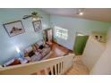Sunlit living room features soaring ceilings, a cozy sofa, and elegant hardwood floors at 5241 E 128Th Way, Thornton, CO 80241