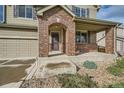 Brick front porch with a covered entryway, leading to the two-story house at 5353 Royal Pine St, Brighton, CO 80601