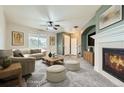 Spacious living room with fireplace, neutral carpeting, and large windows at 5353 Royal Pine St, Brighton, CO 80601