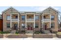 Charming townhome exterior showcasing symmetrical design, multiple balconies, and welcoming curb appeal at 122 N Logan St, Denver, CO 80203