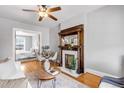 Comfortable living room boasting a fireplace, hardwood floors, ceiling fan and views into the next room at 122 N Logan St, Denver, CO 80203