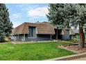 Unique two-story home with blue siding, brown roof, and well-manicured front lawn at 20 Scott Dr, Broomfield, CO 80020