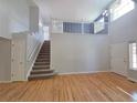 Open-concept living room with hardwood floors and staircase leading to the second floor at 8772 S Carr Way, Littleton, CO 80128