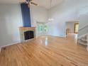 Bright living room with hardwood floors, stone fireplace, and vaulted ceilings at 8772 S Carr Way, Littleton, CO 80128