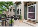 Charming front porch has outdoor seating, potted plants, and a storm door, offering a cozy outdoor space at 9503 Longs Peak Dr, Commerce City, CO 80640